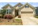 Charming home featuring a two-car garage, manicured landscaping, and stone accents at 103 Margo Ln, Statesville, NC 28677