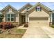 Charming home featuring a two-car garage, manicured landscaping, and stone accents at 103 Margo Ln, Statesville, NC 28677