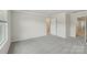 A neutral bedroom with an open door to the ensuite at 108 Ciara Pl # E, Mooresville, NC 28117
