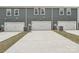 Gray townhome with white garage doors and concrete driveway at 108 Ciara Pl # E, Mooresville, NC 28117