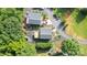 Bird's eye view showcasing two homes with neat landscaping, driveways, and the surrounding tree-filled scenery at 111 Trails End Ln, New London, NC 28127