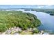 Scenic aerial view of waterfront property, with lake access and lush greenery, offering a serene living experience at 111 Trails End Ln, New London, NC 28127