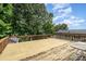 Wide-open wooden deck surrounded by verdant trees, perfect for entertaining or serene relaxation at 111 Trails End Ln, New London, NC 28127