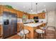 Kitchen with black appliances, wooden cabinetry, kitchen island, and white countertops at 111 Trails End Ln, New London, NC 28127