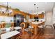 Kitchen with black stainless steel appliances, wooden cabinetry, island, and adjacent breakfast nook at 111 Trails End Ln, New London, NC 28127