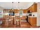 Well-lit kitchen with black appliances, wooden cabinetry, pendant lights, and bar seating at 111 Trails End Ln, New London, NC 28127