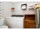 Functional laundry room with a washing machine, dryer, and overhead storage for efficient organization at 111 Trails End Ln, New London, NC 28127
