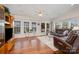 Cozy living room features hardwood floors, large windows, and comfortable leather furniture at 111 Trails End Ln, New London, NC 28127