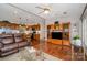 Spacious living room with hardwood floors, ceiling fan, and open access to the kitchen and dining area at 111 Trails End Ln, New London, NC 28127