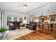 Open-concept living area featuring hardwood floors, comfortable furniture, and a breakfast bar at 111 Trails End Ln, New London, NC 28127