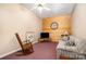 Casual living room with a sofa, rocking chair, and a mounted flat screen for cozy relaxation at 111 Trails End Ln, New London, NC 28127