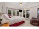 The main bedroom has many windows, a door to the deck and an armchair in the corner at 111 Trails End Ln, New London, NC 28127