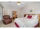 The main bedroom has an armchair, a mirror, a bed, and floral wallpaper at 111 Trails End Ln, New London, NC 28127