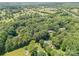 Aerial view of a house nestled among dense trees in a peaceful, secluded, and private wooded neighborhood at 1123 Timberlane Dr, Lincolnton, NC 28092