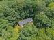 Charming home surrounded by a dense canopy of lush, mature trees, providing a tranquil and secluded setting at 1123 Timberlane Dr, Lincolnton, NC 28092