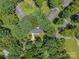 Aerial view of a home nestled among dense, mature trees in a quiet, secluded neighborhood at 1123 Timberlane Dr, Lincolnton, NC 28092