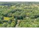 Expansive aerial view of lush, tree-filled landscape surrounding a home with a golf course in the background at 1123 Timberlane Dr, Lincolnton, NC 28092