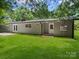 Charming single-story home featuring a well-maintained lawn and a back door to the house at 1123 Timberlane Dr, Lincolnton, NC 28092
