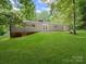 Picture of the back of the house and its well maintained yard that gently slopes away from the home at 1123 Timberlane Dr, Lincolnton, NC 28092