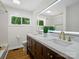 Bathroom with a modern double vanity, a decorative mirror and a window view to the yard at 1123 Timberlane Dr, Lincolnton, NC 28092