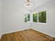 Bedroom with wood flooring, a stylish light fixture, and natural light from the windows at 1123 Timberlane Dr, Lincolnton, NC 28092