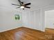 Bedroom featuring a ceiling fan, window, and large closet doors at 1123 Timberlane Dr, Lincolnton, NC 28092