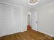 Bedroom featuring wood flooring, natural light, a closet and a doorway to another room at 1123 Timberlane Dr, Lincolnton, NC 28092