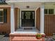 Inviting front entry with a decorated door, white columns, and brick accents at 1123 Timberlane Dr, Lincolnton, NC 28092