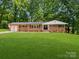 Charming brick home with a lush green lawn and beautiful landscaping at 1123 Timberlane Dr, Lincolnton, NC 28092