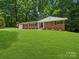 Charming brick home with a lush green lawn and beautiful landscaping at 1123 Timberlane Dr, Lincolnton, NC 28092