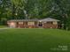 Charming brick home with a lush green lawn and beautiful landscaping at 1123 Timberlane Dr, Lincolnton, NC 28092