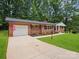 Brick home with attached garage, spacious driveway, and a well-manicured lawn at 1123 Timberlane Dr, Lincolnton, NC 28092