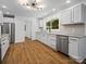 Modern kitchen with stainless steel appliances, white cabinets, granite countertops and hardwood floors at 1123 Timberlane Dr, Lincolnton, NC 28092