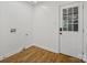 Practical laundry room with wood floors and a door leading to the outside at 1123 Timberlane Dr, Lincolnton, NC 28092
