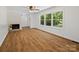 Bright living room featuring refinished hardwood floors, fireplace, and large windows at 1123 Timberlane Dr, Lincolnton, NC 28092