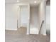 Upstairs hallway with carpet floors, neutral paint, and view of stairs to the basement at 1217 Morehead Dr, Salisbury, NC 28144