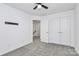 A carpeted bedroom with closet and a modern ceiling fan for style and comfort at 13022 Rover St, Charlotte, NC 28273