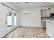 Bright dining area with wood-look floors, modern lighting, and access to the outdoors at 13022 Rover St, Charlotte, NC 28273