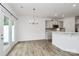 Dining area adjacent to kitchen, with stylish light fixture and access to the outdoor patio at 13022 Rover St, Charlotte, NC 28273