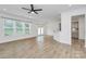Bright living room boasts gorgeous floors, fresh paint, lots of light, and seamless flow to kitchen at 13022 Rover St, Charlotte, NC 28273