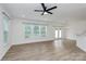 Bright living room boasts gorgeous floors, fresh paint, lots of light, and seamless flow to kitchen at 13022 Rover St, Charlotte, NC 28273