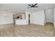 Open-concept living area showcases wood floors and a partial view of kitchen with modern finishes at 13022 Rover St, Charlotte, NC 28273