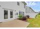 Back patio with white siding and door leading inside, showing a serene outdoor space at 13022 Rover St, Charlotte, NC 28273