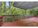 Close up of the back deck with railing and a view of surrounding trees at 131 Canopy Ct, Mooresville, NC 28115