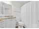 Full bathroom features a granite vanity, shower with curtain, and new toilet at 131 Canopy Ct, Mooresville, NC 28115