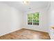 Bright bedroom with wood-look flooring, a large window, and white walls at 131 Canopy Ct, Mooresville, NC 28115