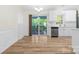Bright dining area features wood floors, wainscoting, and sliding glass doors to the deck at 131 Canopy Ct, Mooresville, NC 28115