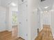 Bright hallway featuring wood-look flooring, white walls, and access to multiple rooms at 131 Canopy Ct, Mooresville, NC 28115