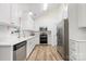 Modern kitchen with stainless steel appliances, white cabinets, and a subway tile backsplash at 131 Canopy Ct, Mooresville, NC 28115