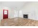 Bright living room features wood floors, a fireplace, and a red front door at 131 Canopy Ct, Mooresville, NC 28115